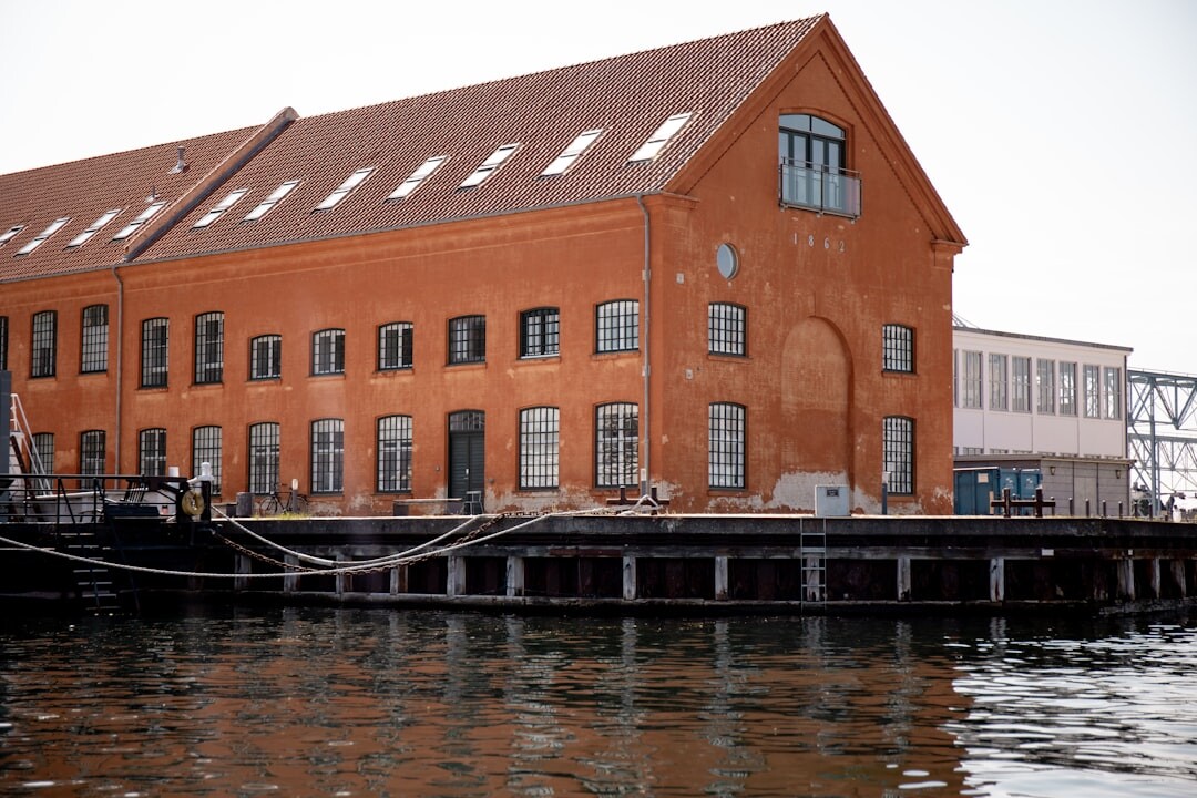 Dock workers unloading fish at a Danish harbor