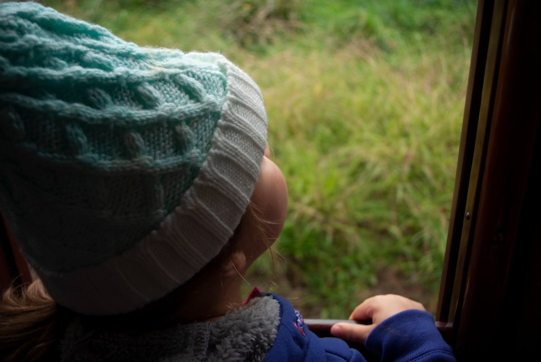 young person dreaming by window